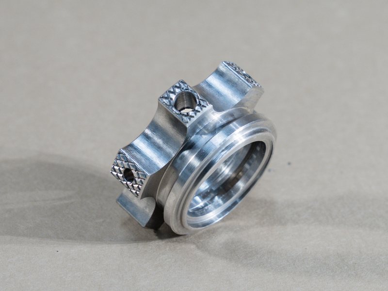 Ring with four knurled, cross-drilled lugs milled around a turned bore