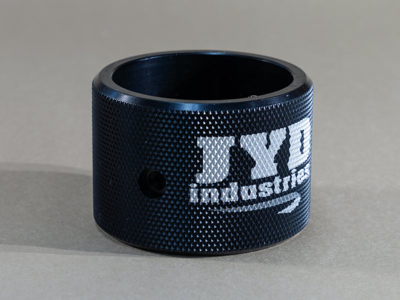 Black knurled ring with a laser-marked JYD Industries logo